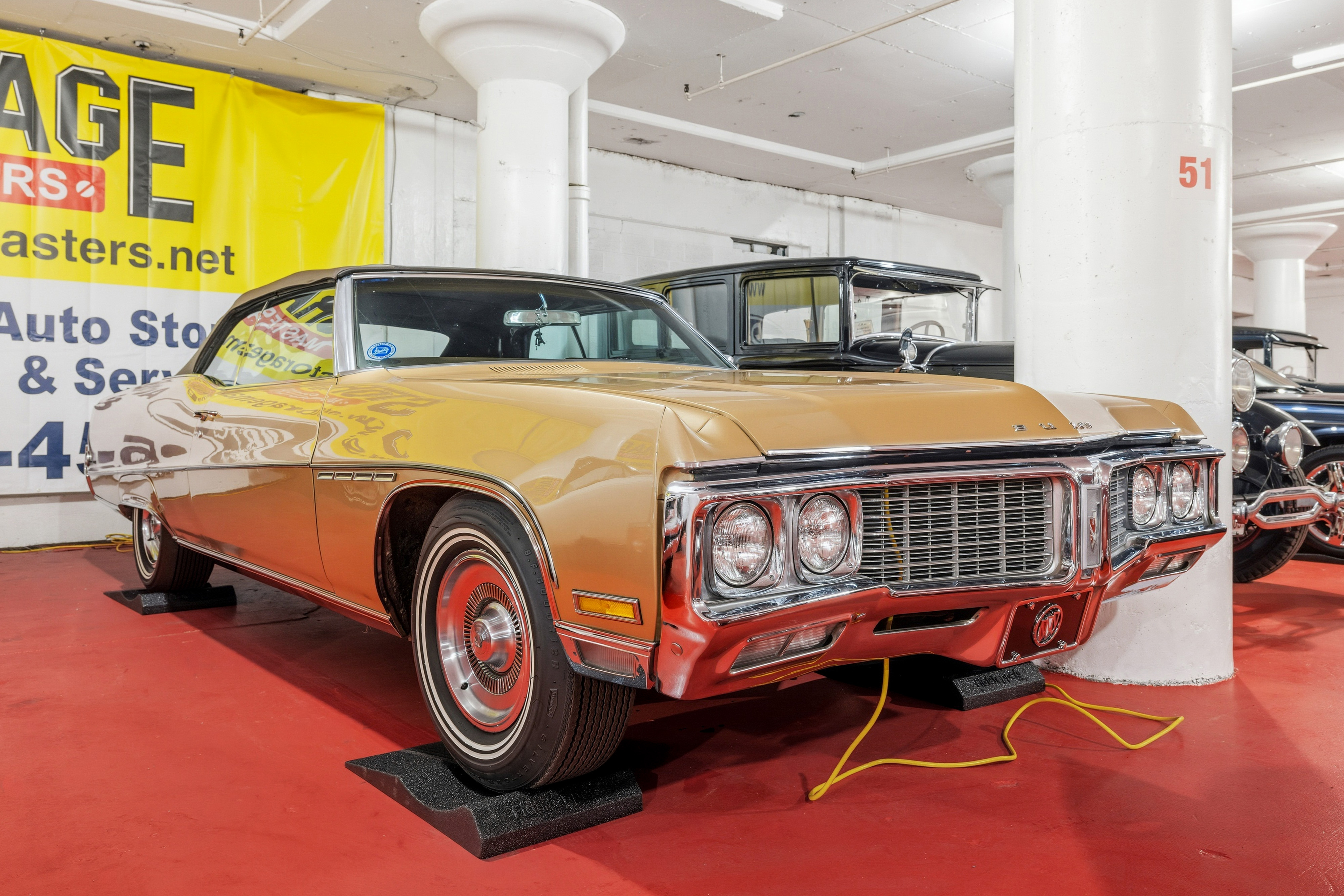 Vintage gold car stored on Flat Stop pads inside our indoor garage